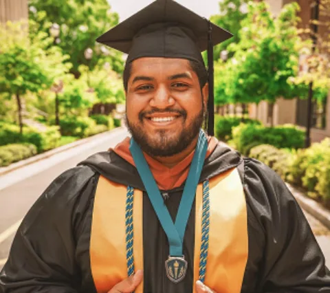 In cap, gown and honor cords with the Honor Society medallion