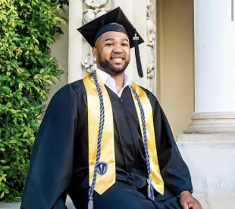 In cap, gown and honor cords with an Honor Society stole